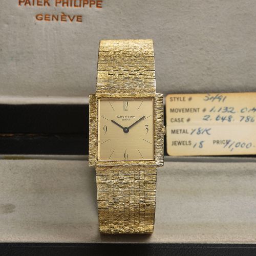 PATEK PHILIPPE REF 3493 YELLOW GOLD. Patek Philippe, Genève, movement No. 1132014, Ref.. 3493. Made circa 1970s.. Very fine and elegant, thin, rectangular, 18K yellow gold. wristwatch with an integrated and bark-finished, 18K. yellow gold Patek Philippe b