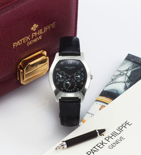 PATEK PHILIPPE REF. 5041 WHITE GOLD. Patek Philippe, Genève, No. 3124024, case No. 4032635, Ref. 5041G. Made in 1998.. Very fine and rare, tonneau-shaped, self-winding, 18K white gold wristwatch with perpetual. calendar, moon phases, 24-hour indication an