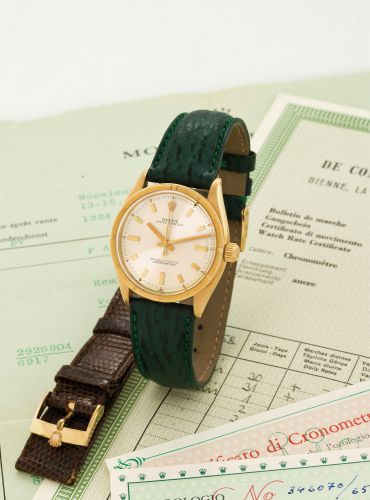 ROLEX REF. 6569, ORIGINAL WARRANTY AND COSC.Rolex, Oyster Perpetual, Officially Certified Chronometer.case No. 346070, Ref. 6569. Sold on February 24th, 1959..Fine, center seconds, self-winding, water-resistant, tonneau.shaped, 18k yellow gold wristwatch 