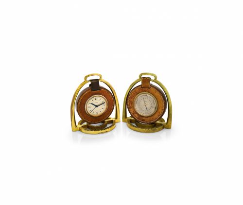 HERMÈS PENDULETTE BAROMETER ÉTRIER.Hermès, Paris, Etrier, the movement by Pontifa-Audoine.Swiss. Made circa 1935..Fine and rare, 8-day going, gilt brass and leather stirrup-.form desk clock with alarm and a matching aneroid.barometer Holosterique, proba