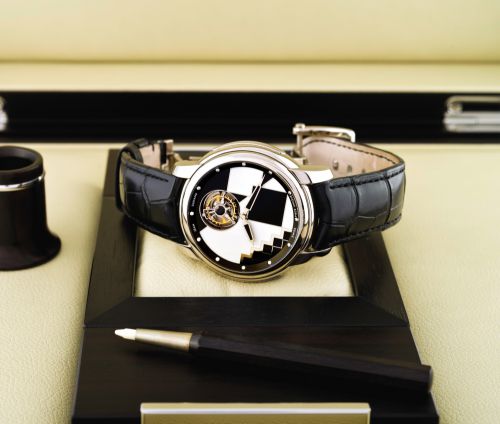 JEAN DUNAND TOURBILLON ORBITAL PIECE UNIQUE WHITE GOLD.Jean Dunand, Tourbillon Orbital, No. IO1961. Made circa 2009..Unique 18K white gold wristwatch with revolving one-minute flying tourbillon.reverse moon phase indication and back-wind and an 18K white 