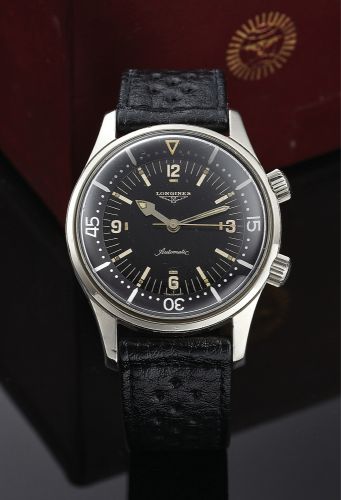 LONGINES REF. 7042 LEGEND DIVER.Longines, Swiss, Ref. 7042-3. Made circa 1964..Very fine and rare, self-winding, center seconds, water-resistant, diver's.wristwatch with inner revolving graduated bezel and a stainless steel.Longines buckle. Accompanied by