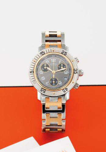 HERMES REF. CL2. 320 CLIPPER CHRONOGRAPH STEEL AND GOLD PALTE.Hermès, Paris. Made circa 1990s. No. 1708339..Fine, steel and gold plate quartz wristwatch with round button chronograph, registers.tachymeter, date, steel and gold plate hermes H motif bracele