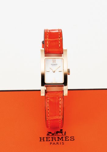 HERMES REF. AC1.185 ALCOR MOTHER OF PEARL AND YELLOW GOLD.Hermès, Paris, Alcor, case No. 2498118, Ref. HH1.185. Made circa 2000..Fine and elegant, rectangular curved, 18K yellow gold lady's quartz wristwatch with.18K yellow gold Hermès backle. Accompanied