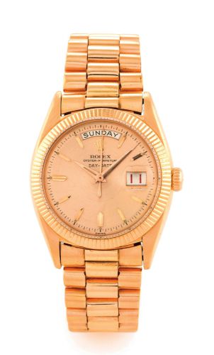 ROLEX REF. 6511, PINK GOLD, PINK DIAL, RED DATE.Rolex, Oyster Perpetual, Day-Date, Superlative Chronometer.Officially Certified, case No. 134692, Ref. 6511. Made circa 1956..Fine and rare, tonneau-shaped, center seconds, self-winding.water-resistant, 18K 