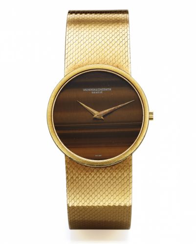 VACHERON CONSTANTIN REF. 7243.TIGER-EYE YELLOW GOLD.Vacheron Constantin, Genève, movement No. 646957, case.No. 488064, Ref. 7243. Made in the 1970s..Fine and unusual, thin, 18K yellow gold wristwatch with.tiger-eye dial and an integral 18k yellow gold V