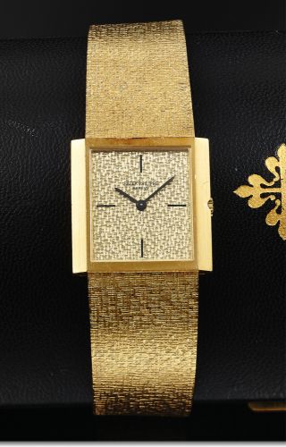 PATEK PHILIPPE REF. 3491 YELLOW GOLD.Patek Philippe, Geneve, movement No. 1162119, case No..2675641, Ref. 3491/4. Made circa 1967..Very fine and rare, rectangular, thin, 18K yellow gold.wristwatch with an integrated 18K yellow gold textured.Patek Philippe