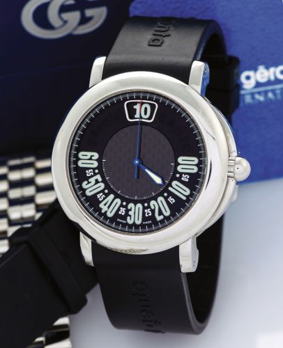 GERALD GENTA STEEL RETRO SPORT.Gérald Genta, Retro Sport, case No. 93623, Ref. G.3694. Made in.the late 1990s..Fine, jump-hour, center-seconds, self-winding, water-resistant.stainless steel wristwatch with retrograde minutes and a black rubber.strap with 
