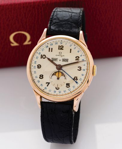 OMEGA COSMIC.Omega, movement No. 11204553, Ref. No. 2486-2. Made circa 1947..Fine and rare, early, pink gold-plated wristwatch with triple date.calendar, moon phases and a gold-plated Omega buckle..Accompanied by an Omega box..Dial, case and movement sign