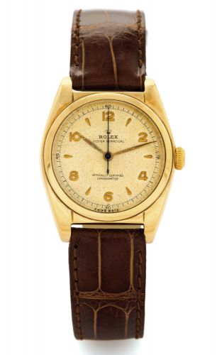 ROLEX REF. 5050 - YELLOW GOLD BUBBLE BACK.Rolex, Oyster Perpetual, Officially Certified, Chronometer.Ref. 5050. Case No. 648322. Made in 1949..Fine and rare, tonneau-shaped, center seconds, self-winding.14K yellow gold wristwatch with a gold-plated Rolex.