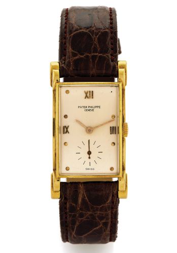 PATEK PHILIPPE REF. 2415 YELLOW GOLD.Patek Philippe, Genève, movement No. 971296, case No..510729, Ref. 2415. Made circa 1948..Fine and rare, rectangular curved, elongated 18K yellow.gold wristwatch..Dial, case, and movement signed.