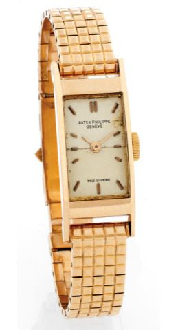 PATEK PHILIPPE REF. 2292 PINK GOLD.Patek Philippe, Genève, No. 843539, case No. 678945, Ref. 2292..Made in 1954, sold on March 12, 1955..Very fine and rare, rectangular, bombé, 18K pink gold wristwatch with an 18K pink gold bracelet with clous de Paris de
