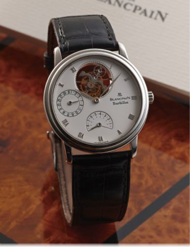 BLANCPAIN TOURBILLON POWER.RESERVE DATE PLATINUM.Blancpain, JB 1735 - Tourbillon, No. 82, Ref. 0023. Made in the.1990's..Very fine and rare, platinum wristwatch with 8-day power.reserve, visible one-minute tourbillon regulator with off-centred.balance, da