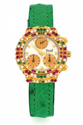 PIAGET, REF. 14071 TANAGRA GOLD.DIAMONDS, RUBIES EMERALDS.Piaget, Genève, Tanagra, Haute Complication.No. 585802, Ref. 14071. Made in the 1990s..Fine, 18K yellow gold, diamond, ruby and emerald-set.lady's quartz wristwatch with round button chronograph.
