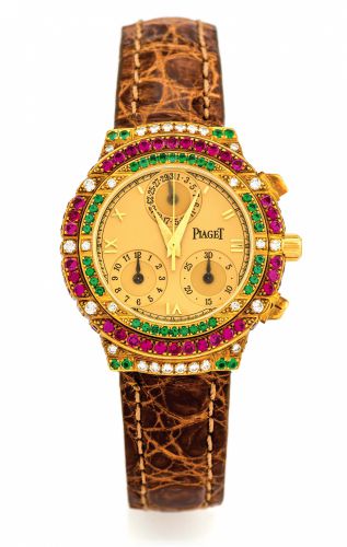 PIAGET, REF. 14071 TANAGRA GOLD.DIAMONDS, RUBIES EMERALDS.Piaget, Genève, Tanagra, Haute Complication, No. 584824.Ref. 14071. Made in the 1990s..Fine, 18K yellow gold, diamond, ruby and emerald-set lady's.quartz wristwatch with round button chronograph,