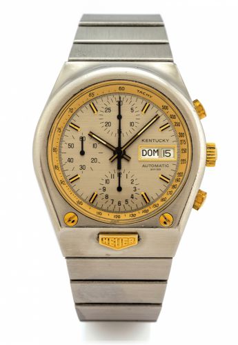 HEUER REF. 750.705 KENTUCKY AUTOMATIC.CHRONOGRAPH DAY/DATE.Heuer, Kentucky, Automatic, case No. 388965, Ref. 750.705..Made circa 1977..Fine, tonneau shaped, water resistant, self-winding, stainless.steel and yellow gold wristwatch, round button chronograp