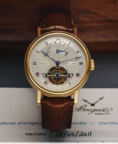 BREGUET REF. 5317 TOURBILLON YELLOW GOLD.Breguet, Tourbillon,  No. 1980, Ref. 5317. Sold May 15, 2011..Very fine and rare, large, skeletonized, self-winding, yellow gold wristwatch with visible.one-minute tourbillon regulator, 5-day power-reserve and an 1