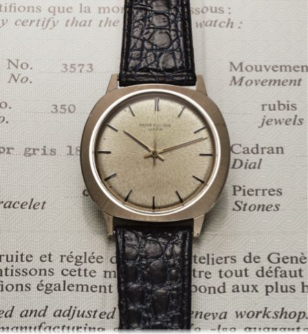 PATEK PHILIPPE REF. 3573 AUTOMATIC BACK-WINDER.Patek Philippe, Genève, No. 1182575, case No. 2693953, Ref. 3573. Made in 1972, sold January 3rd, 1973..Very fine, cushion-shaped, center seconds, self-winding.water-resistant, 18K white gold wristwatch with 