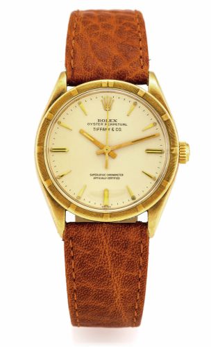 ROLEX REF. 1007 RETAILED BY TIFFANY.14K YELLOW GOLD.Rolex, Oyster Perpetual, Superlative Chronometer, Officially.Certified, case No. 529090, Ref. 1007. Made in 1959..Fine, center seconds, self-winding, water resistant, 14K.yellow gold wristwatch.