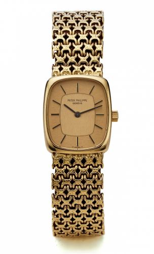 PATEK PHILIPPE REF. 4186/2 YELLOW GOLD.Patek Philippe, Genève. No.1269493, case No. 2743856.Ref. 4186/2. Sold on March 12th, 1975..Fine, tonneau-shaped, 18K yellow gold lady's wristwatch with an integral 18K yellow gold Patek Philippe woven.bracelet. Acco