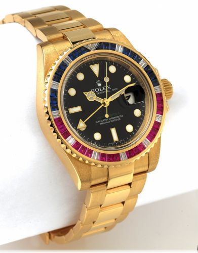 ROLEX REF. 116748 GMT YELLOW GOLD.DIAMONDS RUBIES SAPPHIRES.Rolex, Oyster Perpetual Date GMT Master II.Superlative Chronometer Officially Certified.Ref. 116748 SARU. Made in 2006..Very fine, two time zone, center seconds, self-winding.18K yellow gold wr