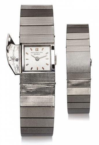 PATEK PHILIPPE REF. 3086 LADY'S.WHITE GOLD CONCEALED DIAL.Patek Philippe Cie, Genève, No..949422, case No. 2602504, Ref. 3086/14..Made circa 1959. Very fine and unusual.rectangular domed, 18K guilloche.white gold lady's wristwatch with.concealed dial an
