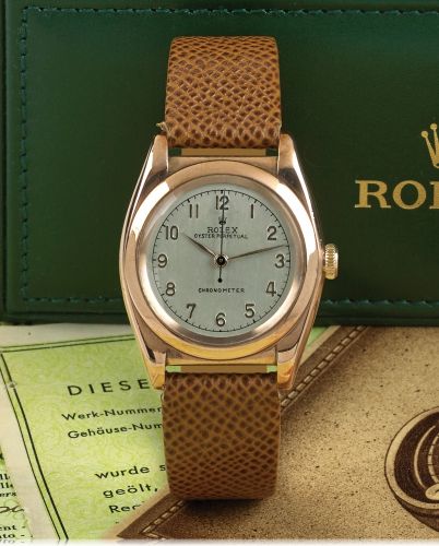 ROLEX REF. 3696 STEEL PINK GOLD.Rolex, Oyster Perpetual, Chronometer, case No. 300734.Ref. 3696. Made in 1945..Fine and rare, tonneau-shaped, center seconds, self-winding.18K pink gold and stainless steel wristwatch with a gold-plated.Rolex buckle. Acco