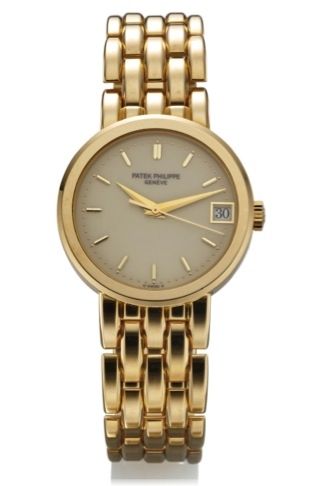 PATEK PHILIPPE REF. 5012.IVORY DIAL YELLOW GOLD.Patek Philippe, Genève, movement No. 1914069, case No..2938738. Ref. 5012/3. Made in 1993..Very fine, center seconds, self-winding, water-resistant.18K yellow gold wristwatch with date and an integral 18K.ye