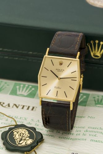 ROLEX REF. 3805 CELLINI WHITE GOLD Rolex, Genève, Cellini, Ref. 734. Sold in January 1989. Very fine, cushion-shaped, 18K yellow gold wristwatch with an 18k yellow gold Rolex buckle. Accompanied by the original Cellini box hang tag and warranty.