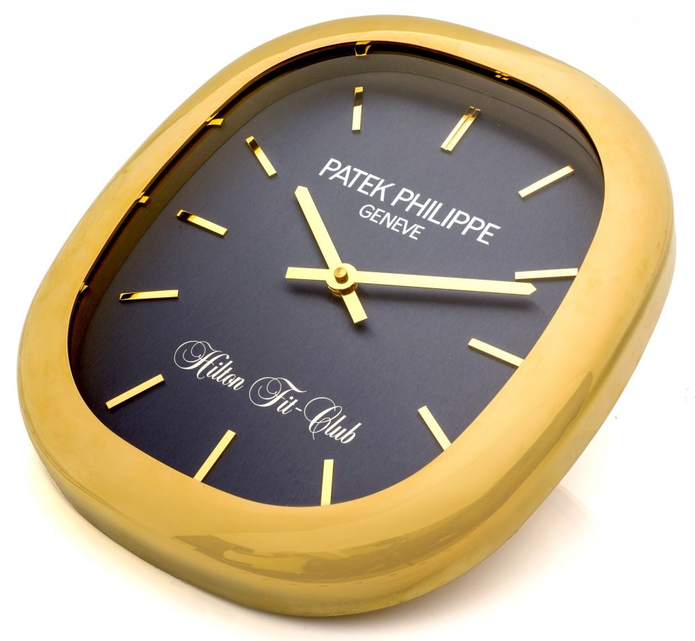 KIENZLE MADE FOR PATEK PHILIPPE, ELLIPSE WALL CLOCK A fine and rare, brass quartz Ellipse wall clock made for Hilton Fit Club In excellent overall condition AAA