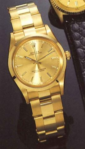 Rolex, Oyster Perpetual, Superlative Chronometer.Officially Certif ied, Ref. 14208, present series..Fine, tonneau shaped, center second, self winding.18ct gold gentleman's wristwatch, with 18 ct gold Oyster bracelet, with fitted box and certificate.
