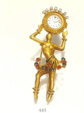 Rolex, Ref. 8792. Produced in the 1940's..Very fine and rare, 18K pink gold, sapphire, ruby and diamond lady's clip-watch representing a Hawaiian dancer holding on her head a symbol of the sun.