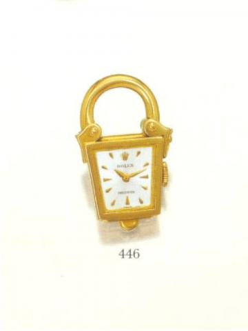 Rolex Precision, Ref. 8858. Produced in the 1950's..Fine and unusual, trapezoidal, 18K yellow gold padlock- and lantern-shaped trinket watch, hanging from the padlock ring-bow, opening on the right side by means of a jewelery hook.
