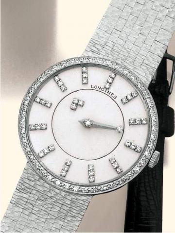 Longines, Myst_rieuse, cased by Longines-Wittnauer Watch Co., New York-Montreal, Ref. 528-167 B. Produced in the 1950's.Fine and unusual 18K white gold and diamond, mystery gentleman's wristwatch with a 14K white gold hammered and tiled bracelet.