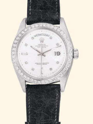 Rolex, Oyster Perpetual Day Date, Superlative Chronometer Officially Certi-fied, Ref. No. 6613. Produced in the late 1950's.Very fine, tonneau-shaped, center-seconds, self-winding, water-resistant, platinum and diamonds gentleman's wristwatch with day and