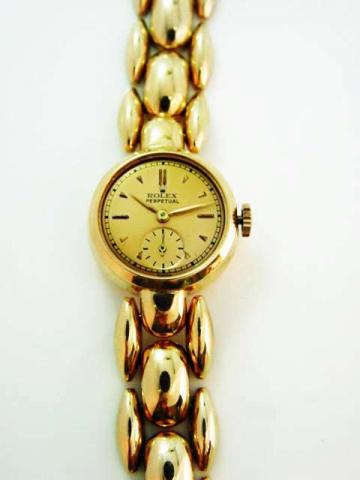 Rolex, Perpetual, Ref. 4487. Produced in the 1940's. Fine and unusual, self-winding, 18K pink gold lady's wristwatch with an integrated 18K pink gold fancy link Rolex bracelet and clasp.