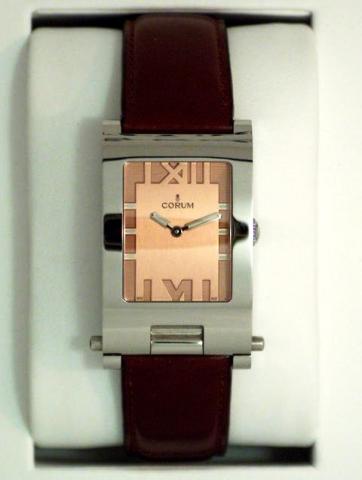 Corum, Tabogan, Ref. 56.151.20. Produced in the 1990's, sold on January 15, 2003..Fine and unusual, water-resistant, asymmetric, rectangular curved, stainless steel quartz gentleman's wristwatch bearing a sliding and hinged mechanism which transforms the 
