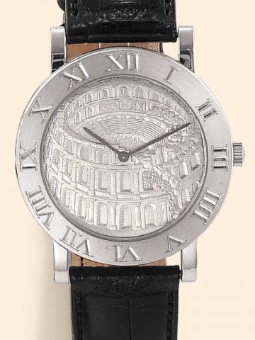 Corum, Romulus Coliseum, No. X, Ref. 587.09.59. Produced in 1997 in three series of 100 examples each, in yellow, pink and white gold. Sold on January 15, 2003.Extremely fine and rare, self-winding, water-resistant, 18K white gold gentleman's wristwatch w