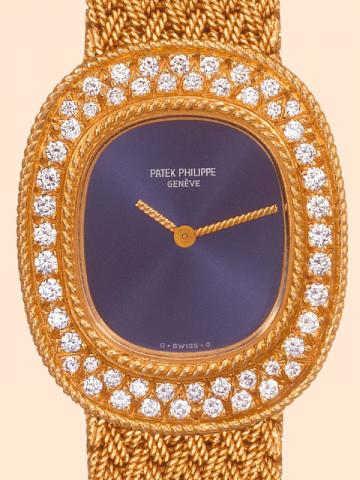 Patek Philippe Cie, Geneve, No. 1391012, case No. 2763710, Ref. 4396/1. Produced in the 1980 's. Very fine, oval, 18K yellow gold and diamonds lady's wristwatch with an 18K yellow gold woven Patek Philippe bracelet 