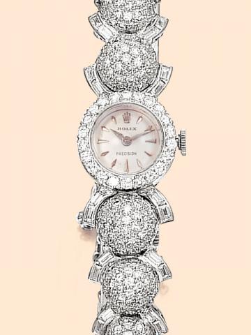 Rolex Precision, Ref. 8916. Produced in the 1950s. Fine and unusual, 18K white gold and diamond lady's wristwatch with a bracelet consisting in graduated ball-shaped elements entirely paved with round diamonds and surrounded by semi-circular motifs set wi