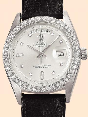 Rolex, Oyster Perpetual Day Date, Superlative Chronometer Officially Certified, Ref. No. 6613. Produced in the late 1950's. Very fine, tonneau-shaped, center-seconds, self-winding, water-resistant, platinum and diamond gentleman's wristwatch with day and 