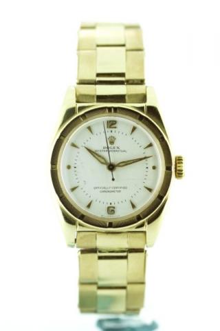 Rolex Oyster Perpetual, Officially Certified Chronometer, Ref. 6015. Produced in the 1950 's.Very fine and rare, tonneau shaped, center-seconds, self-winding, water-resistant, 10K yellow gold gentleman's wristwatch with a 14K yellow gold Oyster bracelet.