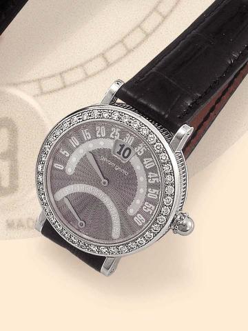 G_rald Genta, Retro, Ref. G 3714. Produced circa 2000.Fine and unusual, jump-hour, self-winding, water-resistant, 18K white gold and diamond gentleman's wristwatch with retrogrademinutes, retrograde date and an 18K white gold G_rald Genta buckle.
