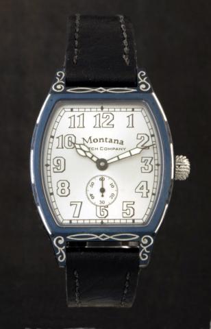 Montana Watch Co, No. 4, Ref. 1925. Produced in a limited edition of 100 examples in 2002, sold in 2002.Fine, tonneau-shaped, self-winding, blued steel and silver wristwatch. Accompanied by a fitted wooden box and extra strap