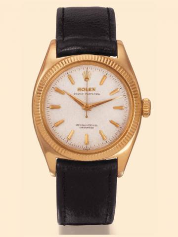 Rolex Oyster Perpetual, Officially Certified Chronometer, Ref. 6502. Manufactured in the 1960s. Very fine and rare, tonneau-shaped, center-seconds, self-winding, water-resistant, 18K yellow gold gentleman's wristwatch with a gold-plated Rolex buckle and a
