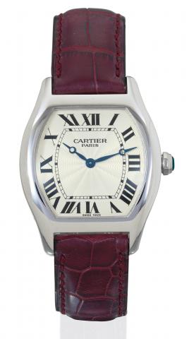Cartier, Collection.Priv_e, Tortue.No. 0069 MG, Ref..2518D. Produced circa 2000..Very fine, tonneau-shaped, waterresistant.platinum gentleman's wristwatch.and an 18K white gold Cartier.deployant clasp. Accompanied by a.fitted box and certificate.