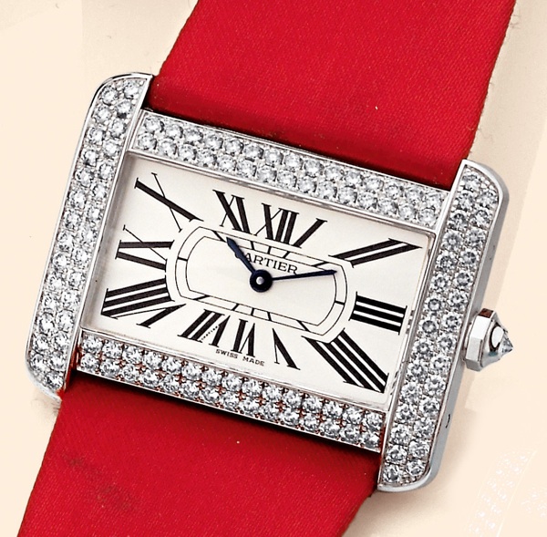Tank Divan.Cartier, Tank Divan, Ref. 2614. Production of this model started in 2002..Fine and unusual, horizontal rectangular and curved, center-seconds, water-resistant, 18K white gold.and diamond-set wristwatch with an 18K white gold Cartier buckle. Acc