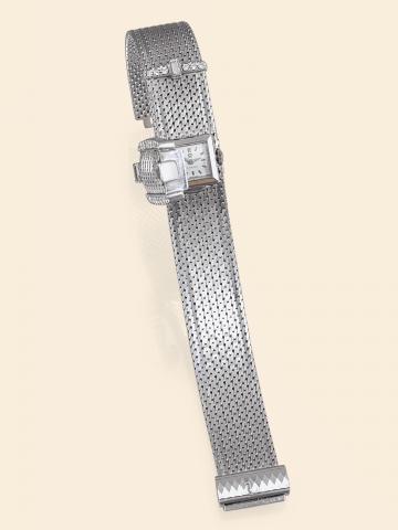 Omega, No. 17695611, case No. 486787.Ref. 8029. Made in the 1950s..Fine, 18K white gold and diamond-set lady's.bracelet watch with concealed dial and an integral 18K white.gold mesh bracelet in the form of a belt and buckle.