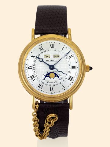 Serpentine.Breguet, Serpentine, No. 207, Ref. 3332.retailed by Tiffany Co. Made in the 1980s..Very fine, astronomic, self-winding, 18K yellow gold gentleman's.wristwatch with triple date, moon phases, age of the.moon, an 18K yellow gold Breguet buckle a
