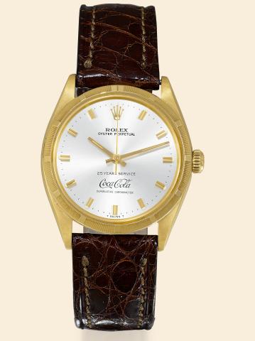 Ref. 1003, Yellow Gold COCA-COLA.Rolex, Oyster Perpetual, 25 Years service.Coca-Cola, Superlative Chronometer.case No. 3044042, Ref. 1003/1005. Made In 1972..Very rare, fine and interesting, water-resistant, center.seconds, self-winding, tonneau-shaped, 1